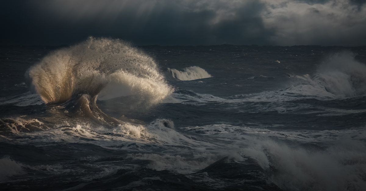Powerful ocean waves under stormy skies. Photo by Ray Bilcliff on Pexels.
