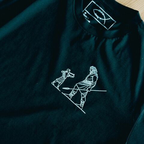 David and Goliath tee laid flat on oak